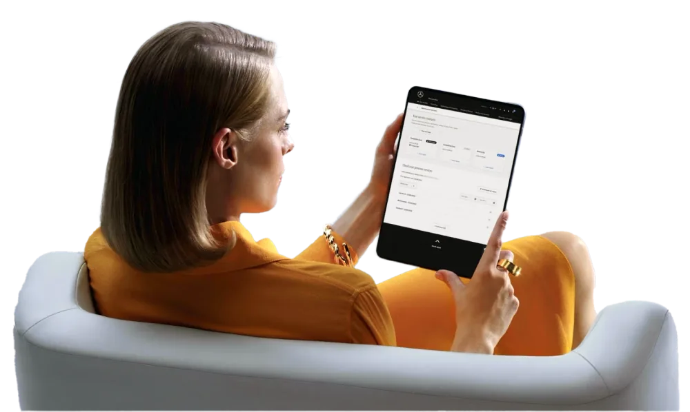 Woman using tablet to book European car service appointment online